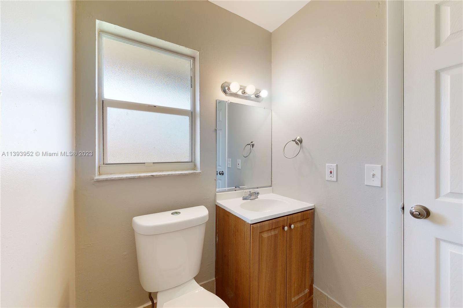 16813 Southwest 107th Place Miami, FL 33157 - Photo 12 of 28 a bathroom with a toilet sink and mirror