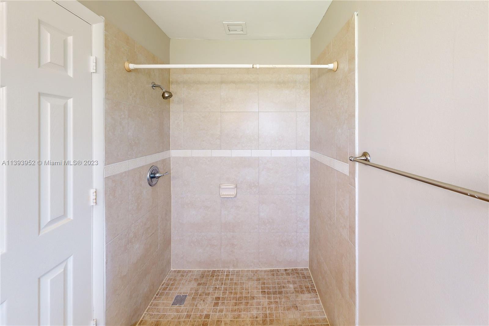 16813 Southwest 107th Place Miami, FL 33157 - Photo 14 of 28 a bathroom with a glass shower door