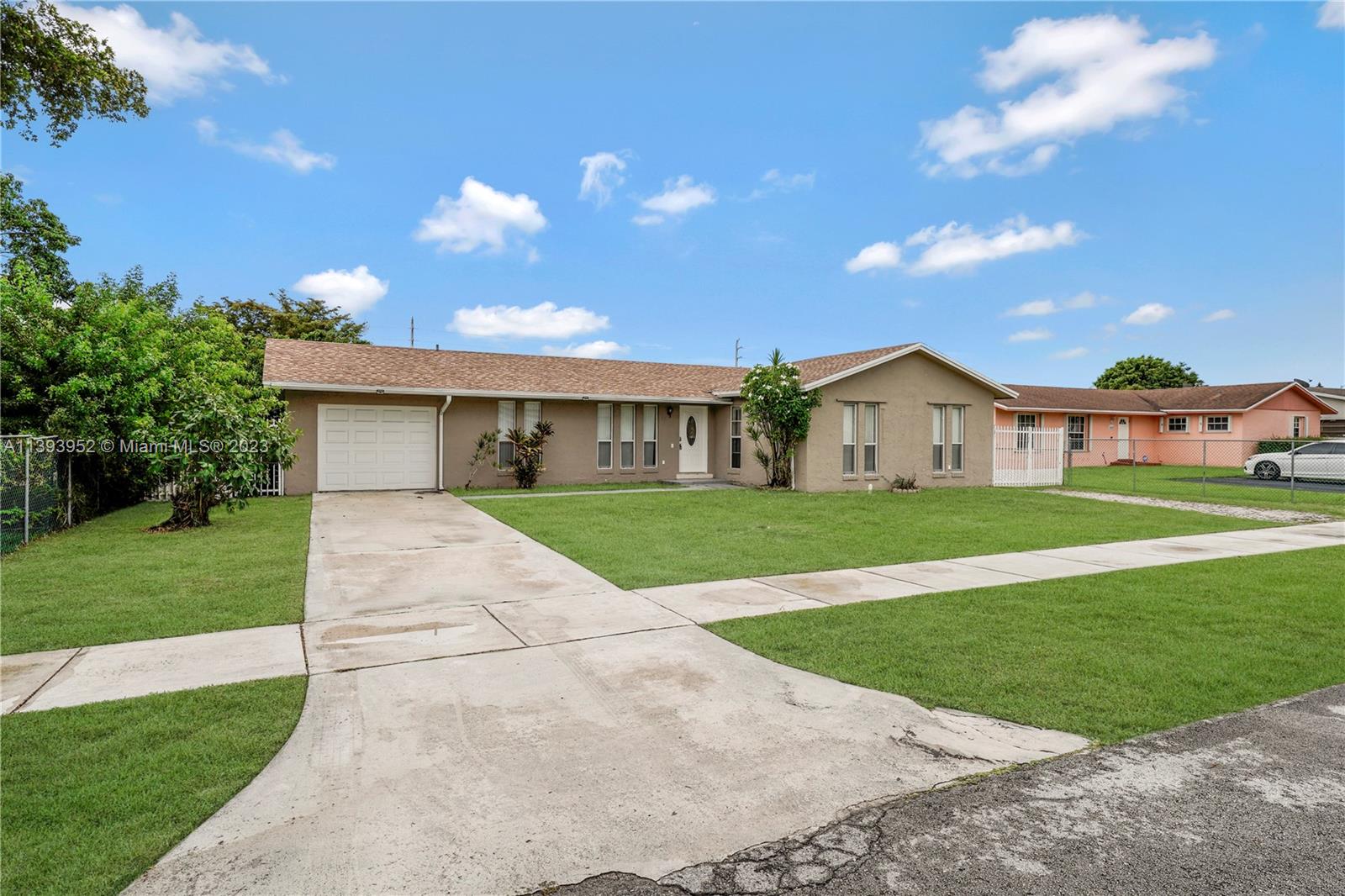 16813 Southwest 107th Place Miami, FL 33157 - Photo 2 of 28 a front view of a house with a yard