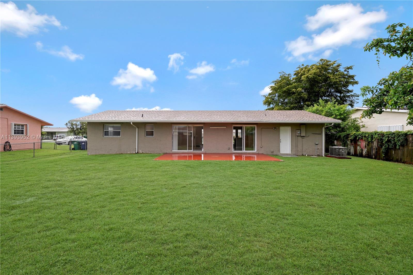 16813 Southwest 107th Place Miami, FL 33157 - Photo 24 of 28 a front view of a house with a yard and garage
