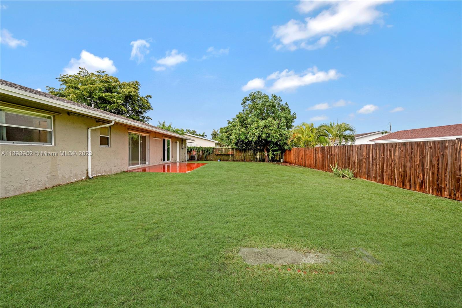 16813 Southwest 107th Place Miami, FL 33157 - Photo 25 of 28 a view of a backyard with plants and a garden