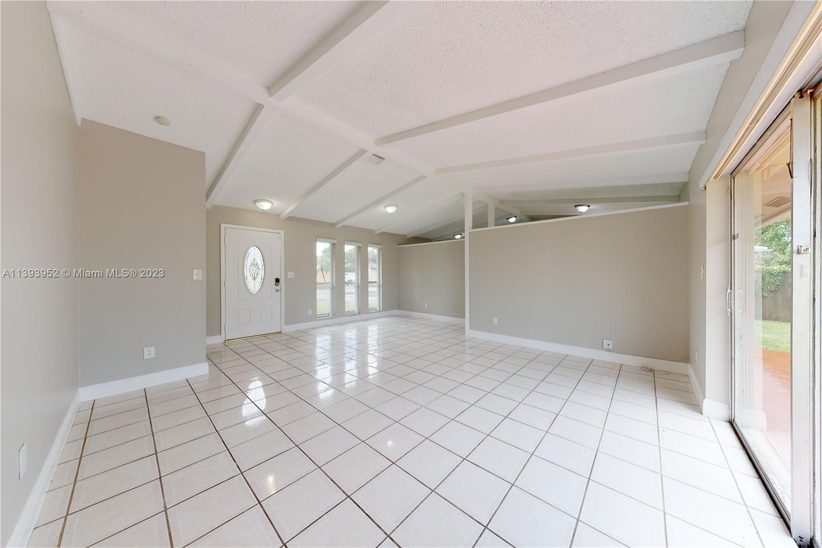 16813 Southwest 107th Place Miami, FL 33157 - Photo 3 of 28 a view of an empty room and window