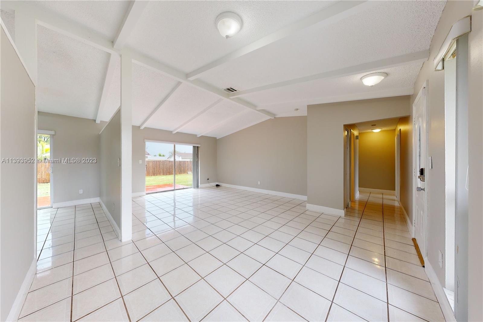 16813 Southwest 107th Place Miami, FL 33157 - Photo 4 of 28 a view of an empty room and window