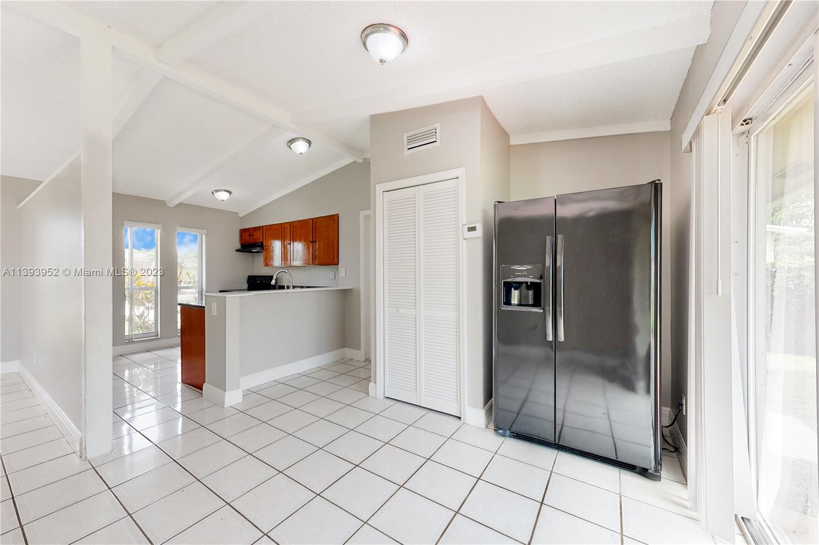 16813 Southwest 107th Place Miami, FL 33157 - Photo 6 of 28 a view of a refrigerator in kitchen and a windows