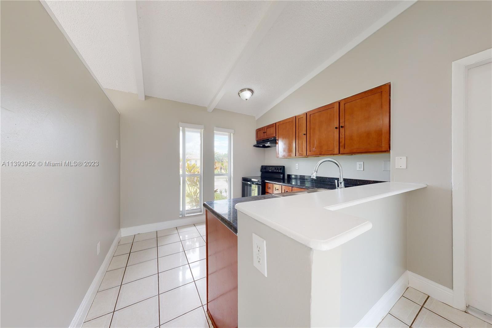 16813 Southwest 107th Place Miami, FL 33157 - Photo 7 of 28 a view of kitchen with stainless steel appliances cabinets and outdoor space