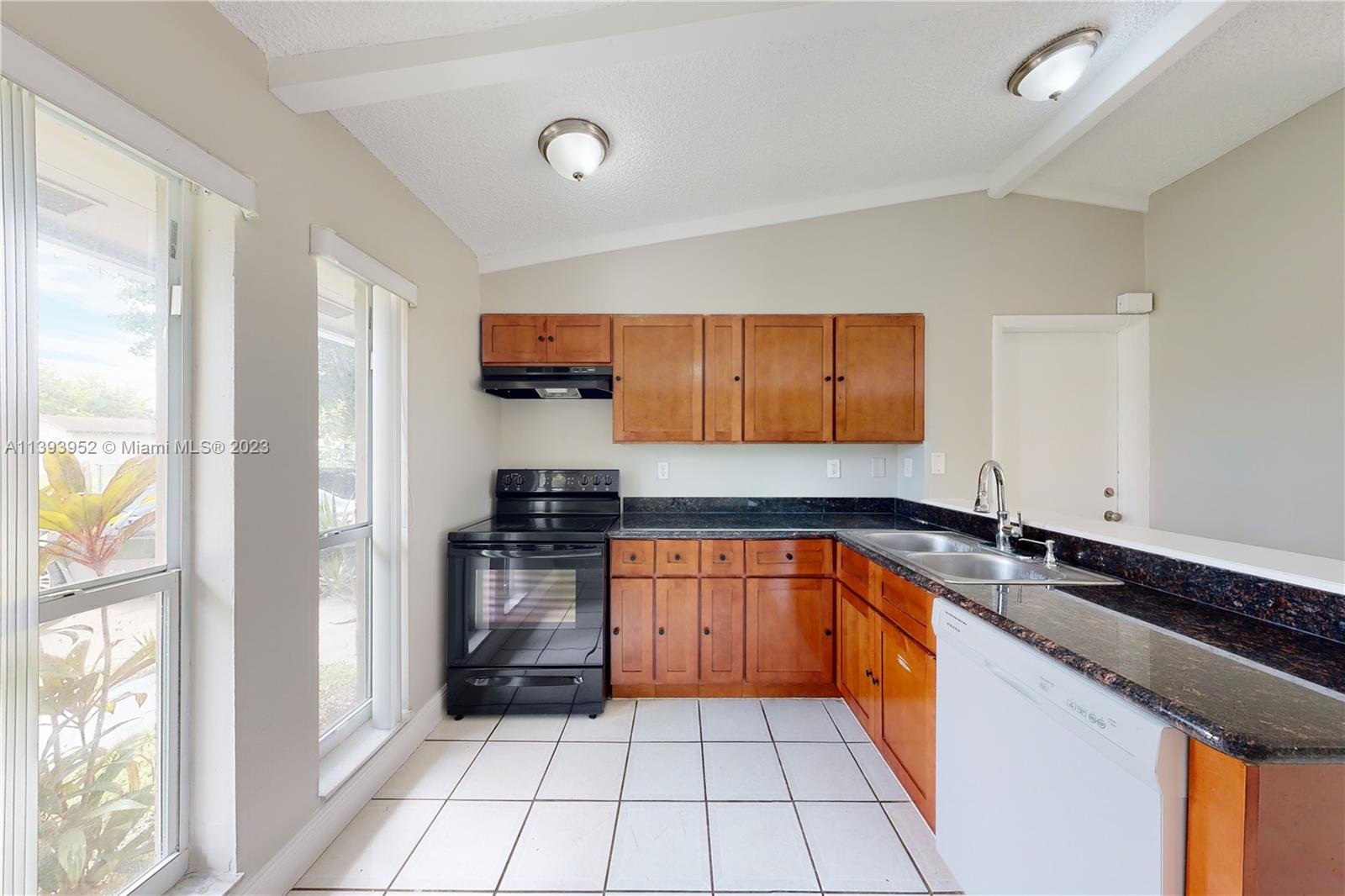 16813 Southwest 107th Place Miami, FL 33157 - Photo 8 of 28 a kitchen with stainless steel appliances granite countertop a refrigerator and a sink