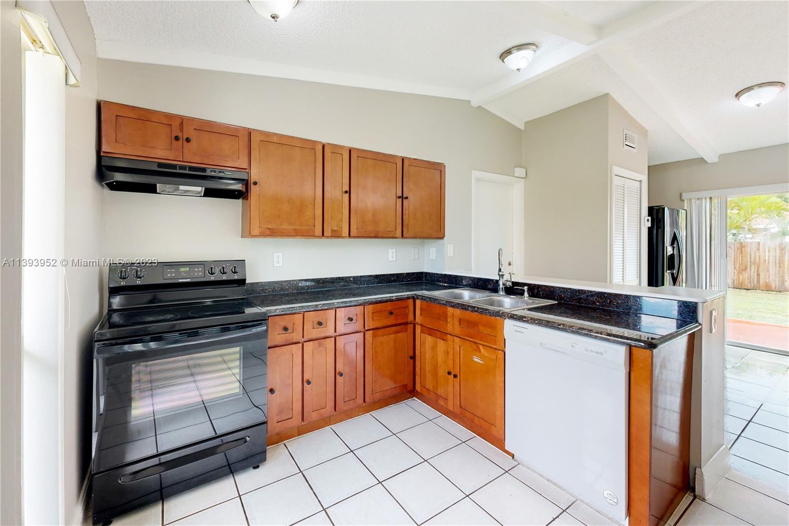 16813 Southwest 107th Place Miami, FL 33157 - Photo 9 of 28 a kitchen with stainless steel appliances granite countertop a stove and a sink