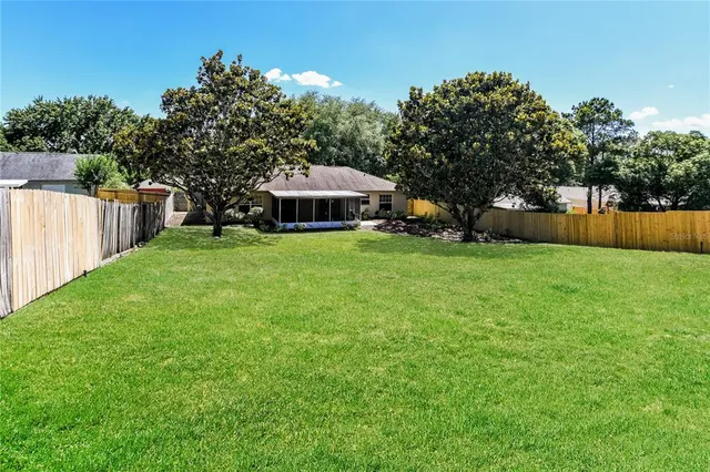 a view of a house with a yard and sitting area