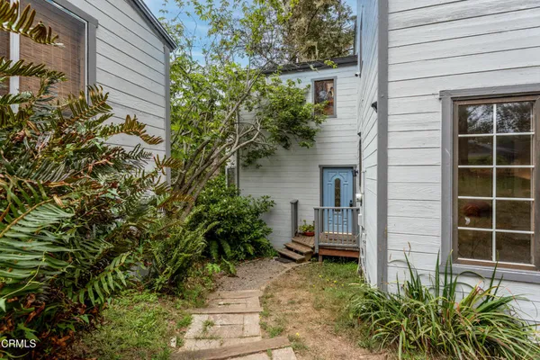 a house that has a potted plant and a window