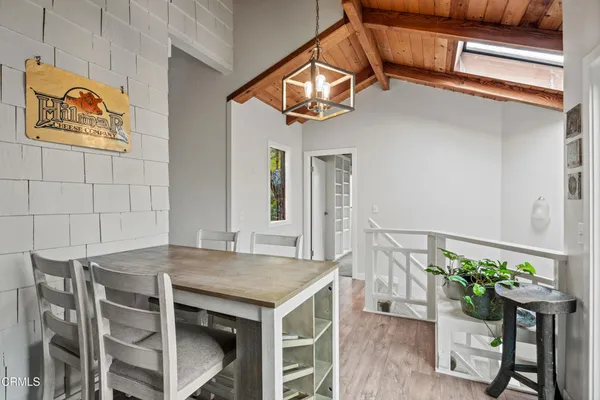 a view of a dinning table and chairs in the balcony