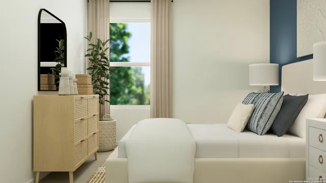 a bedroom with a bed and a potted plant next to a window