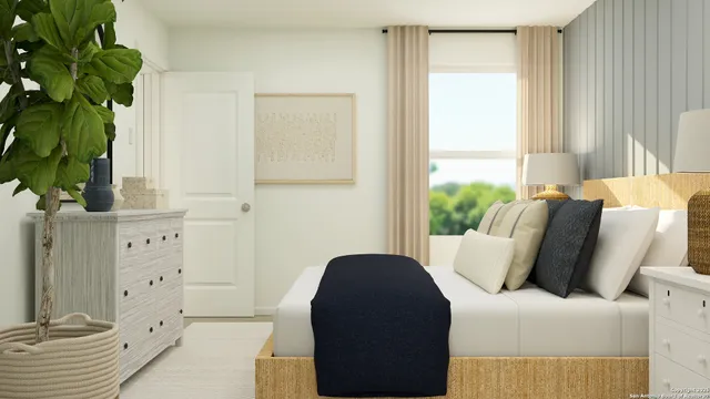 a living room with furniture lamp and a potted plant