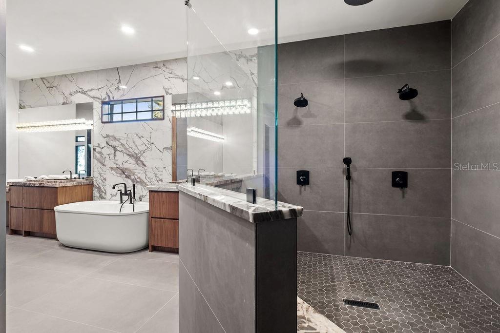 9725 Chestnut Ridge Drive Windermere, FL 34786 - Photo 26 of 64 a bathroom with a tub sink mirror and shower