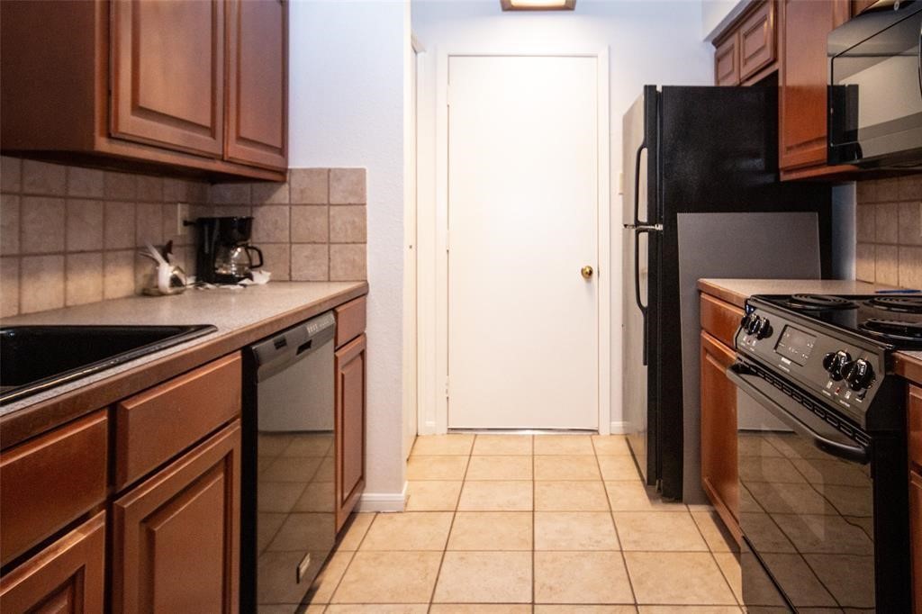 2425 Holly Hall Street, Unit 31 Houston, TX 77054 - Photo 3 of 9 a kitchen with a stove and a refrigerator
