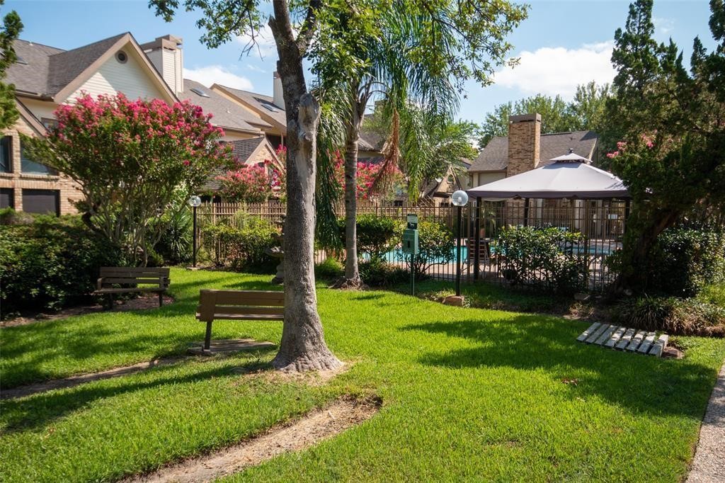 2425 Holly Hall Street, Unit 31 Houston, TX 77054 - Photo 4 of 9 a view of a garden with a bench and trees