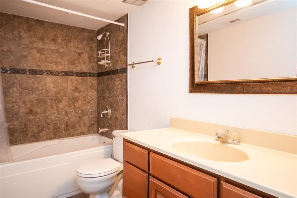 2425 Holly Hall Street, Unit 31 Houston, TX 77054 - Photo 6 of 9 a bathroom with a sink a toilet and bathtub