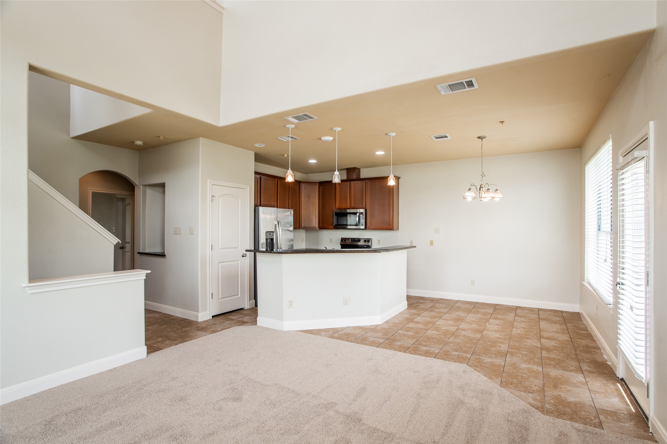 1010 Immanuel Road, Unit 128 Pflugerville, TX 78660 - Photo 4 of 17 An inviting open-concept layout seamlessly connects the kitchen and living areas, offering effortless daily living.