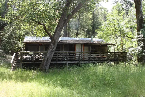 a front view of house with yard and outdoor seating