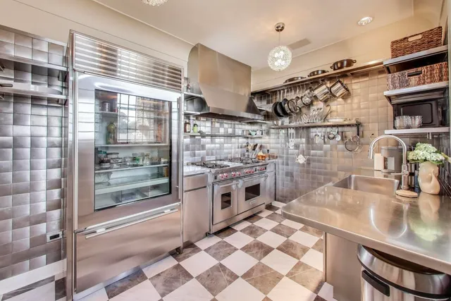 a kitchen with stainless steel appliances granite countertop a sink and cabinets