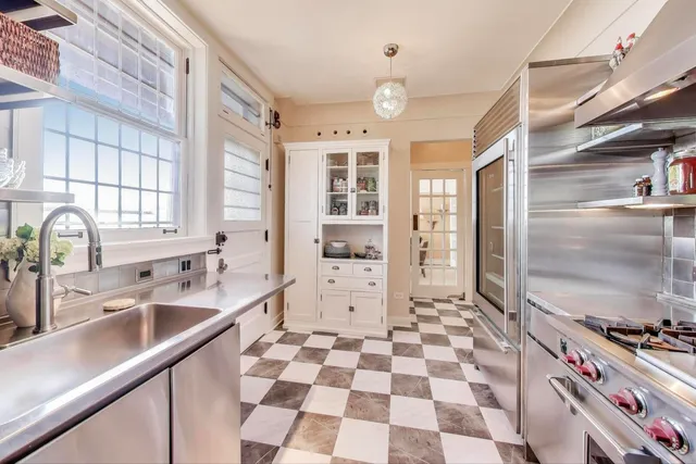 a kitchen with a sink a stove and a refrigerator
