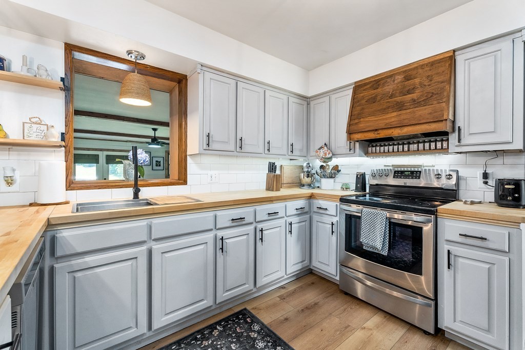 1653 Lester Flatt Road Sparta, TN 38583 - Photo 12 of 59 a kitchen with white cabinets and white appliances