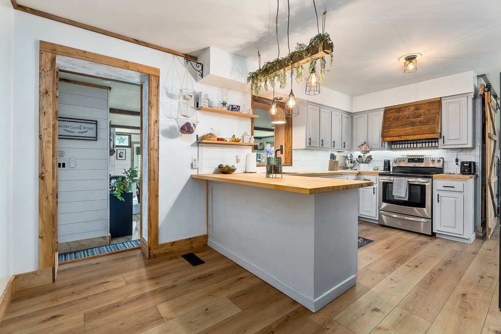 1653 Lester Flatt Road Sparta, TN 38583 - Photo 13 of 59 a kitchen with kitchen island granite countertop wooden floors and a sink
