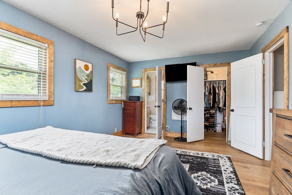 1653 Lester Flatt Road Sparta, TN 38583 - Photo 23 of 59 a bedroom with a bed and a chandelier