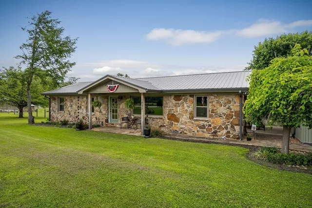 a view of a chair and table on the green field