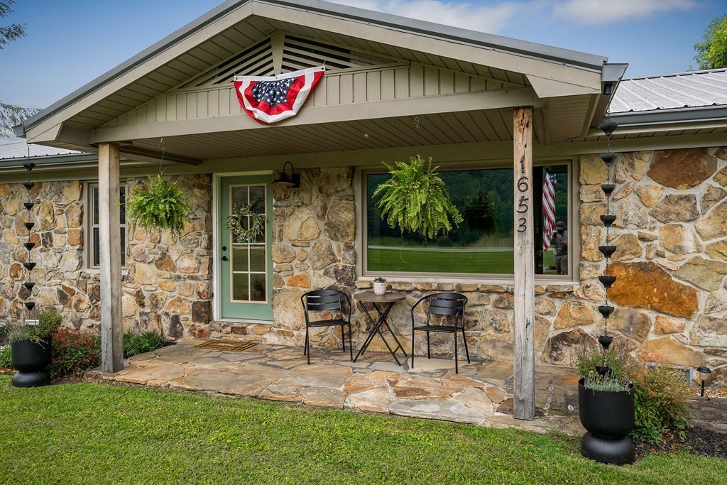 1653 Lester Flatt Road Sparta, TN 38583 - Photo 47 of 59 a view of a patio with table and chairs potted plants