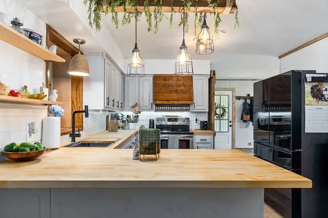 a kitchen with a sink stove and cabinets