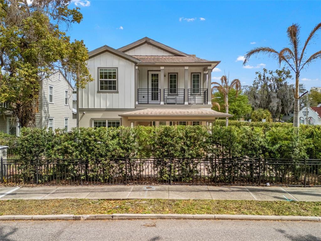 a front view of a house with a yard and potted plants