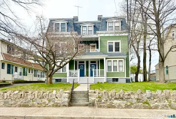 a front view of a building with a garden