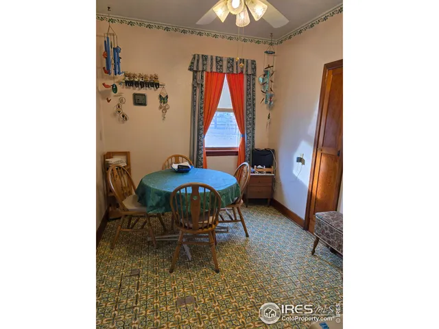 a dining room with furniture and a window
