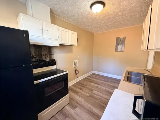 a kitchen with granite countertop a stove and a refrigerator