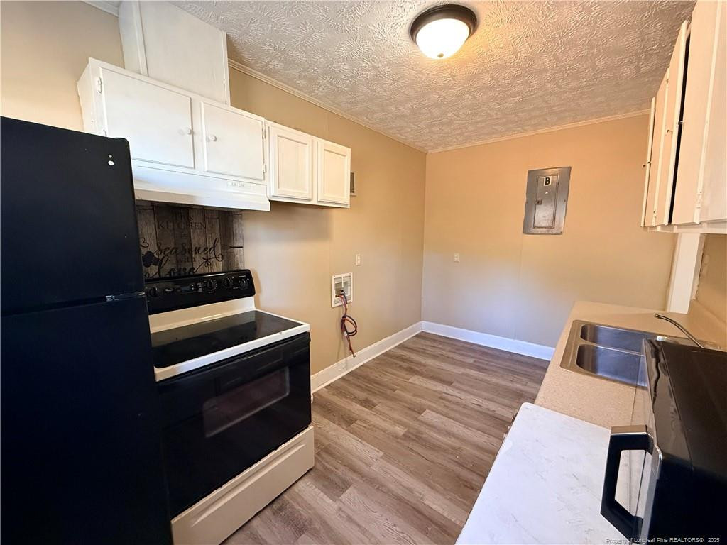 1106 Clark Street, Unit B Fayetteville, NC 28305 - Photo 11 of 12 a kitchen with granite countertop a stove and a refrigerator