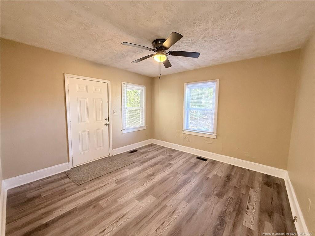 1106 Clark Street, Unit B Fayetteville, NC 28305 - Photo 3 of 12 a view of an empty room with window and wooden floor