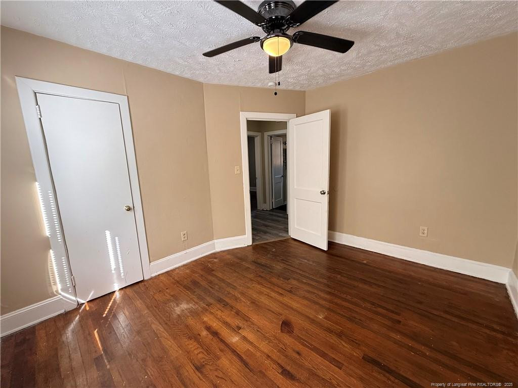1106 Clark Street, Unit B Fayetteville, NC 28305 - Photo 4 of 12 wooden floor in an empty room with a window