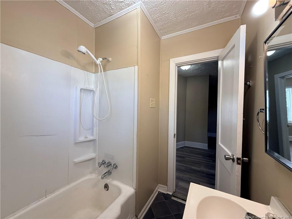 1106 Clark Street, Unit B Fayetteville, NC 28305 - Photo 7 of 12 a bathroom with a bathtub shower vanity and a toilet