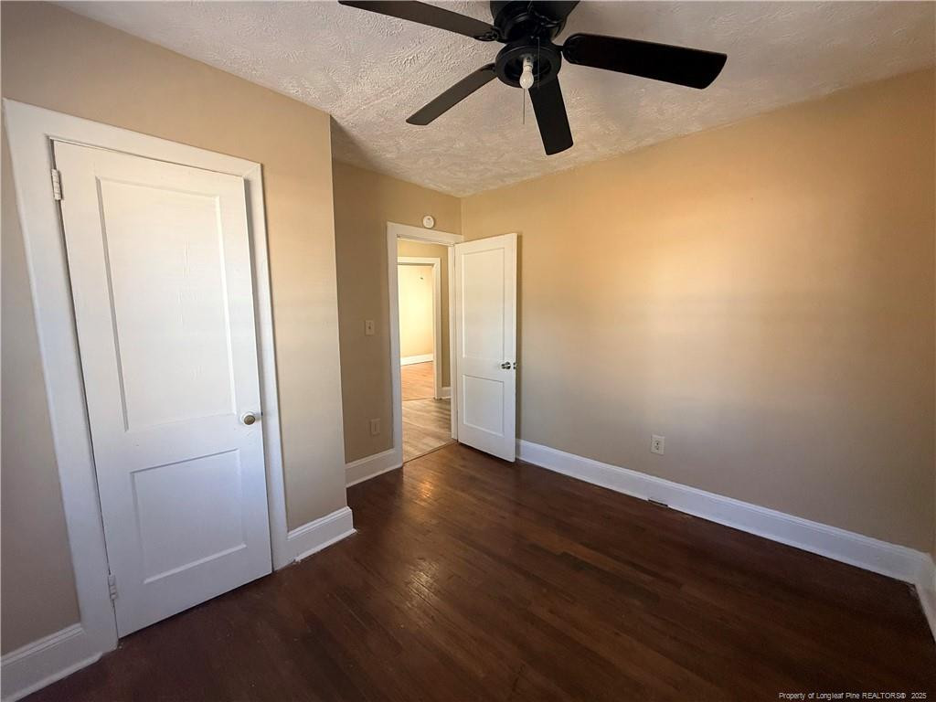 1106 Clark Street, Unit B Fayetteville, NC 28305 - Photo 8 of 12 an empty room with wooden floor closet and windows
