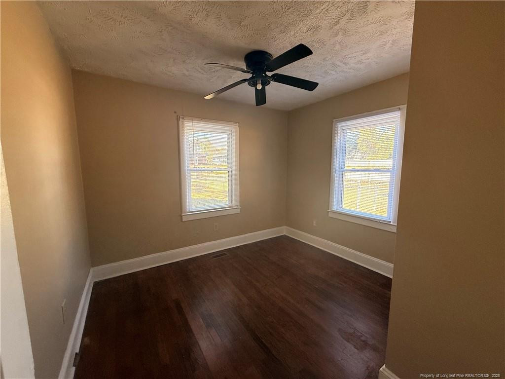 1106 Clark Street, Unit B Fayetteville, NC 28305 - Photo 9 of 12 a view of empty room with wooden floor and fan