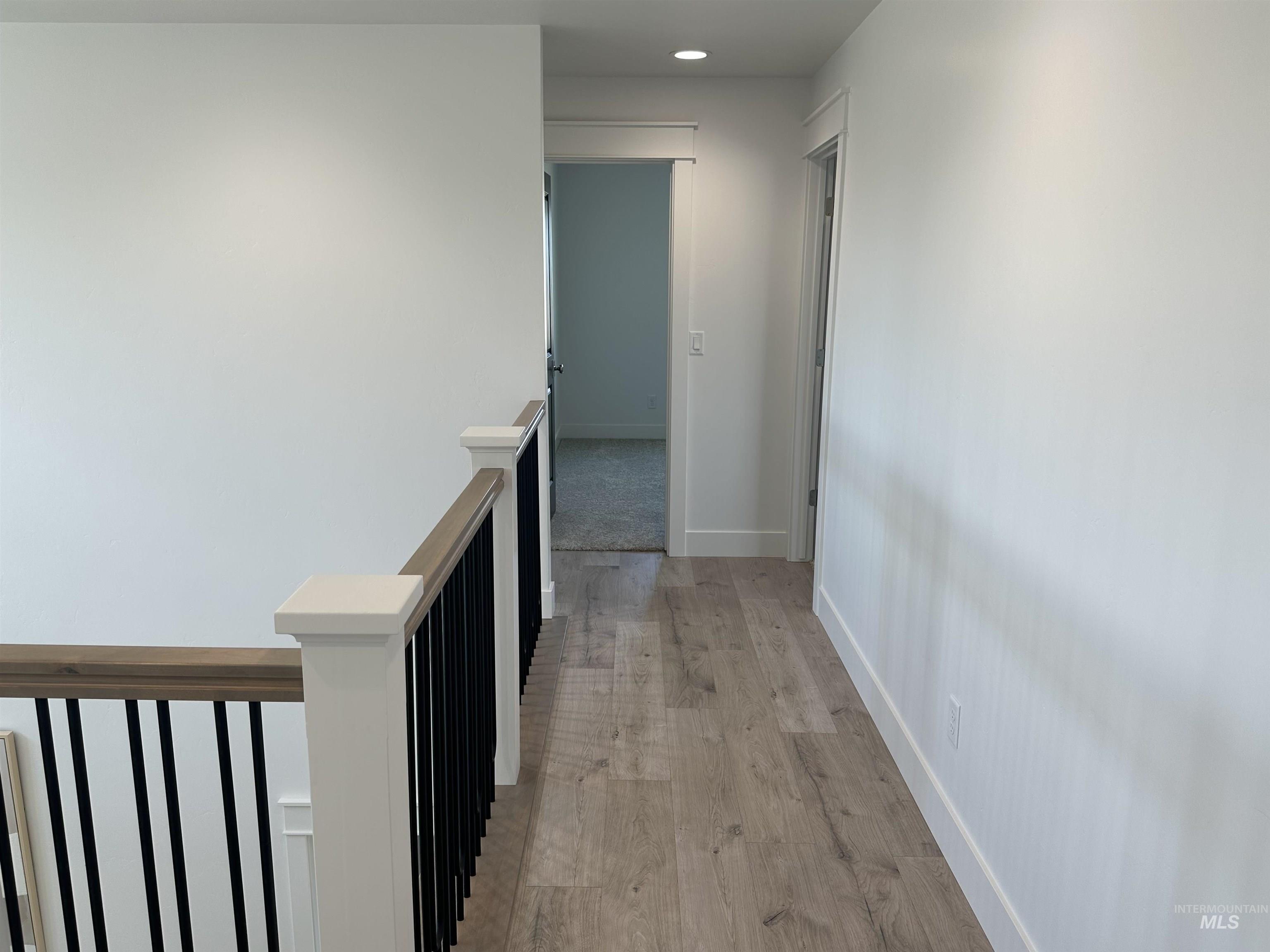 3035 Lake View Twin Falls, ID 83301 - Photo 36 of 41 Upper-level hallway with light wood-finish flooring, white walls, and recessed lighting