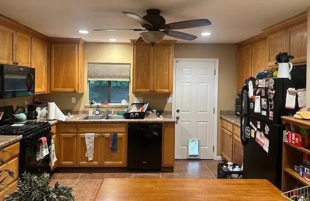 a kitchen with stainless steel appliances granite countertop a stove and a sink