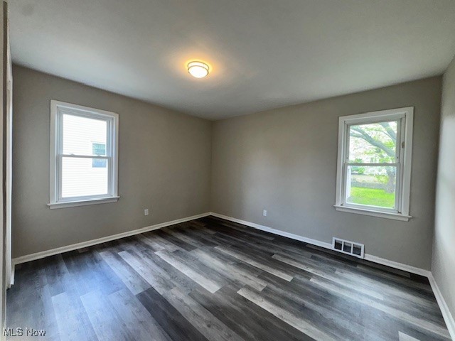28846 Alton Road Wickliffe, OH 44092 - Photo 19 of 27 Unfurnished room featuring visible vents, baseboards, and dark wood-style floors