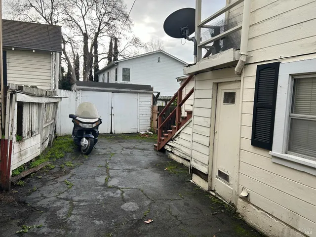 a view of a house with a large tree