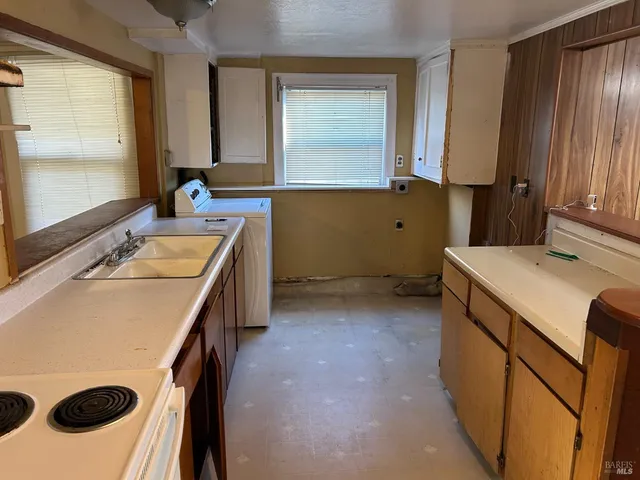 a room with a sink a stove and a refrigerator