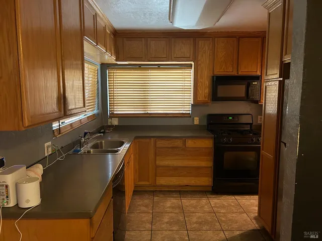 a kitchen with a refrigerator and a sink