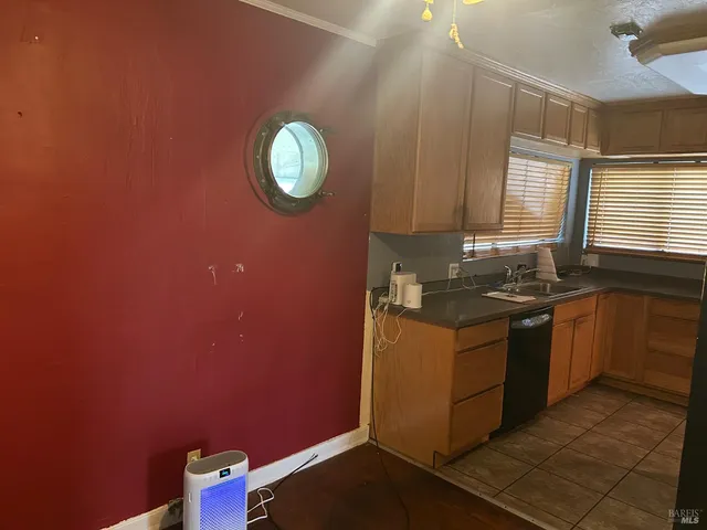 a kitchen with stainless steel appliances granite countertop a sink and a stove top oven