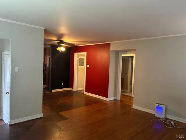 an empty room with wooden floor and closet