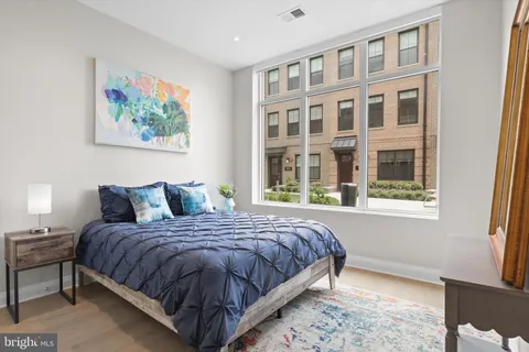 a bedroom with a large bed and a window