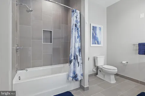 a bathroom with a toilet and a bathtub